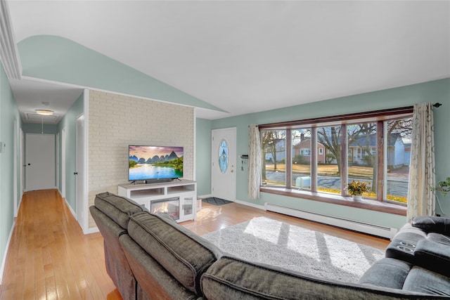 living room with attic access, baseboards, lofted ceiling, light wood-style flooring, and baseboard heating