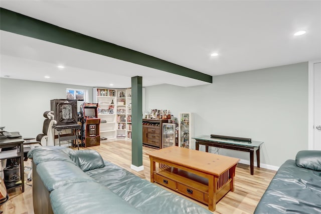 living area with baseboards, recessed lighting, and light wood-style floors