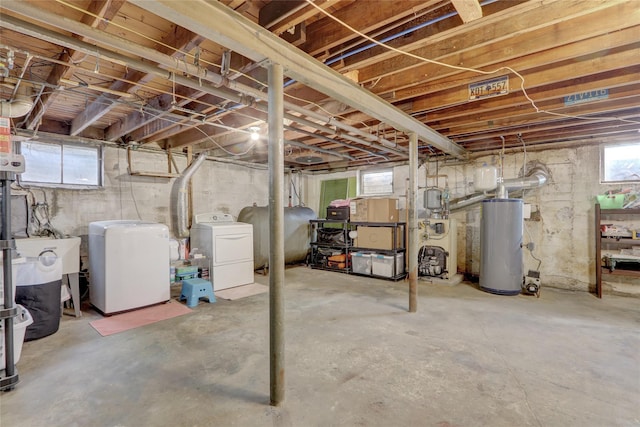 basement with heating fuel, gas water heater, and washer and dryer