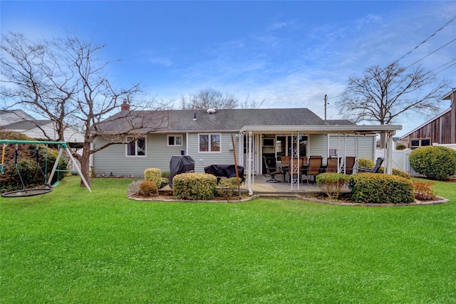 back of property with a patio area, fence, a playground, and a yard