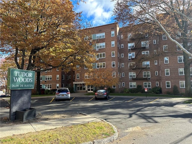 view of building exterior featuring uncovered parking