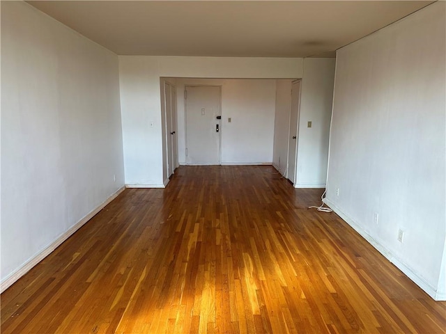 empty room featuring dark wood finished floors