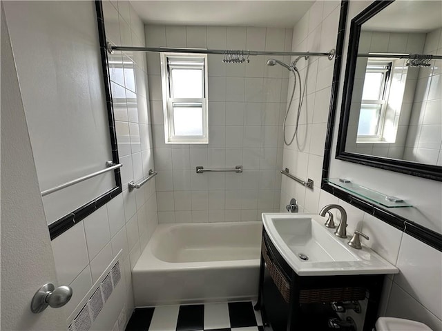 full bathroom featuring shower / washtub combination, tile walls, visible vents, toilet, and vanity