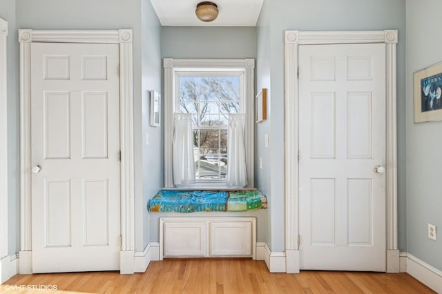 entryway with light wood-style floors and baseboards