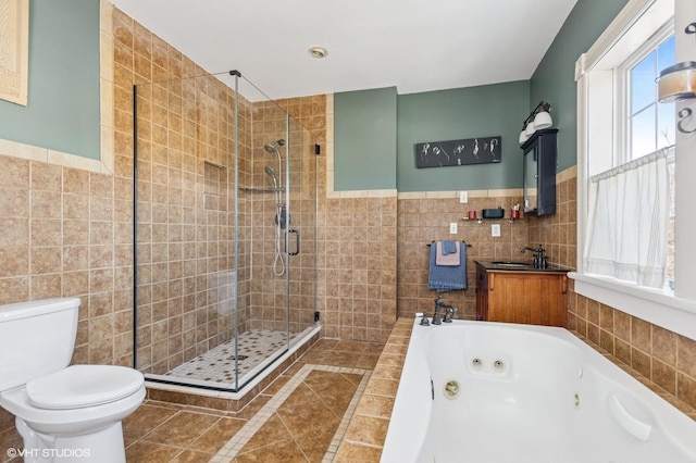 bathroom with tile walls, toilet, a stall shower, a whirlpool tub, and tile patterned floors