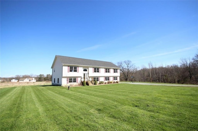 bi-level home with a front lawn