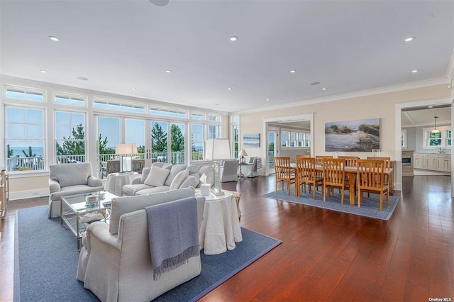 living area with ornamental molding, recessed lighting, dark wood finished floors, and baseboards