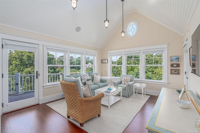 interior space with dark wood-style floors, high vaulted ceiling, and baseboards