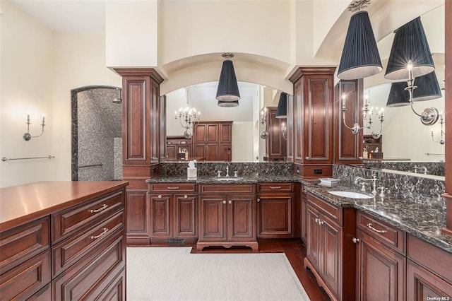 full bath featuring ornate columns, decorative backsplash, and vanity