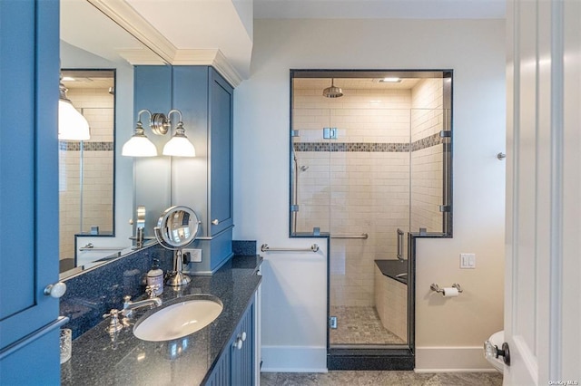 full bath with a shower stall, baseboards, and vanity