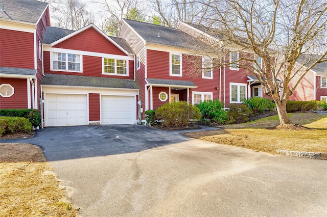 townhome / multi-family property featuring driveway and an attached garage