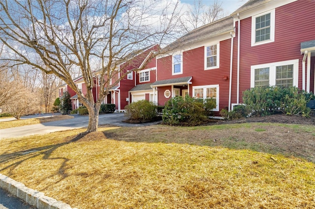 view of front of home with driveway, a front lawn, and a garage