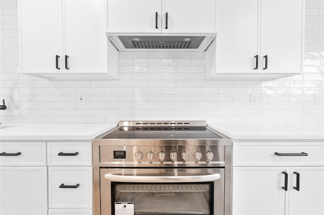 kitchen featuring white cabinetry, range hood, stainless steel electric range, and tasteful backsplash