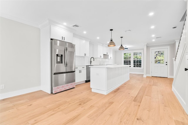 kitchen with visible vents, tasteful backsplash, white cabinetry, stainless steel appliances, and light countertops