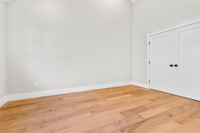 spare room featuring light wood-style flooring and baseboards