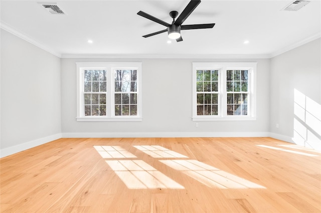 unfurnished room with crown molding, wood finished floors, and visible vents