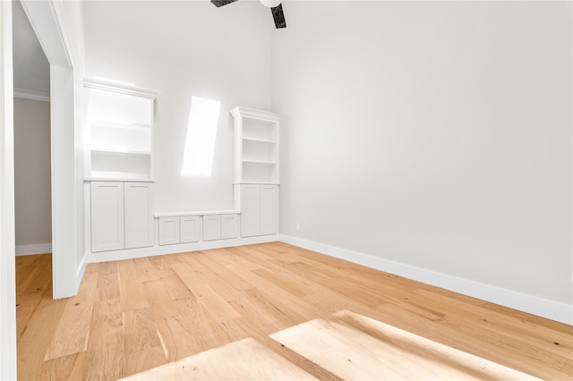 unfurnished room featuring light wood-style flooring and baseboards