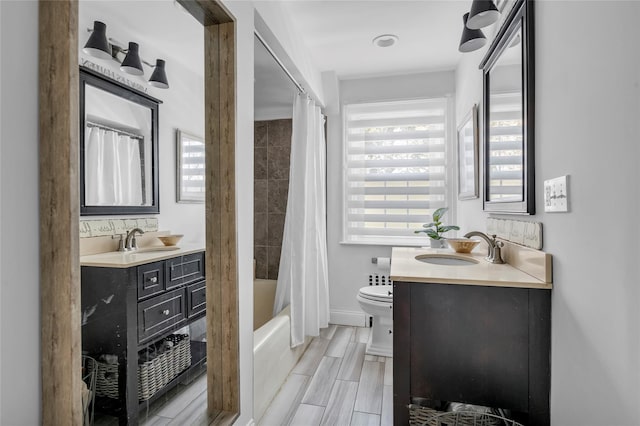 full bathroom with toilet, shower / bath combo, plenty of natural light, and vanity