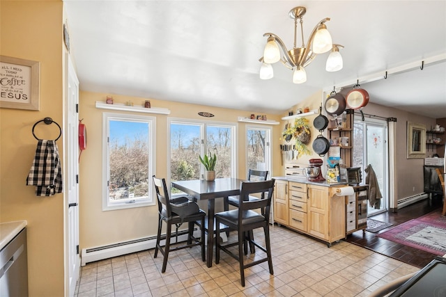 dining area with a baseboard radiator, a notable chandelier, and baseboards