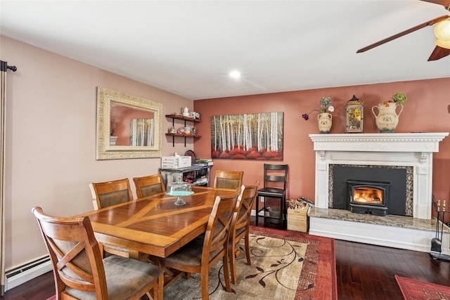 dining room with ceiling fan, recessed lighting, a premium fireplace, wood finished floors, and baseboard heating