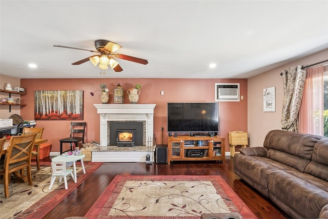 living room with ceiling fan, a wall unit AC, hardwood / wood-style flooring, and recessed lighting