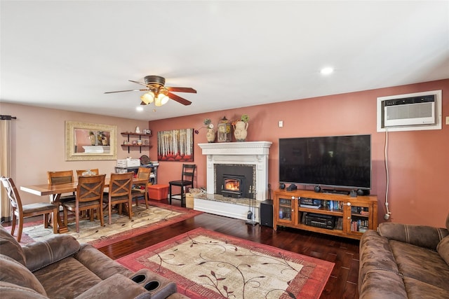 living area featuring ceiling fan, wood-type flooring, a wall unit AC, and recessed lighting