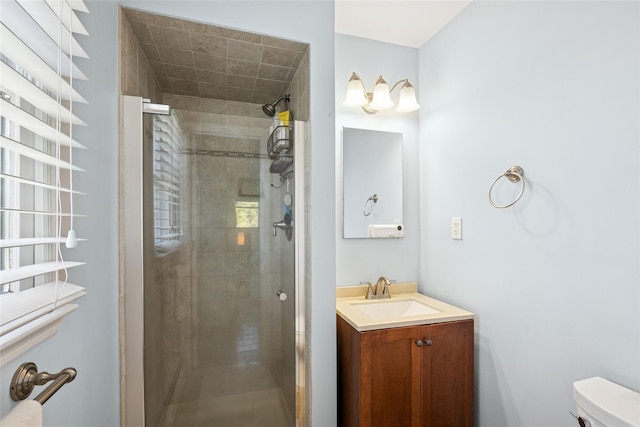 full bathroom with a stall shower, vanity, and toilet