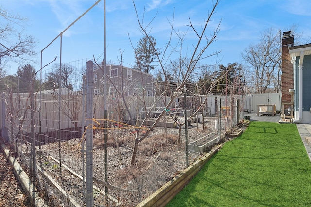 view of yard featuring fence private yard and a vegetable garden