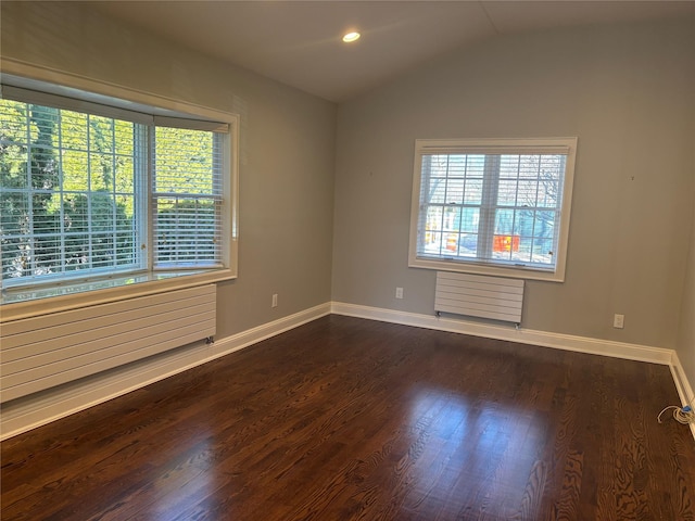 unfurnished room with dark wood-style floors, recessed lighting, radiator, vaulted ceiling, and baseboards