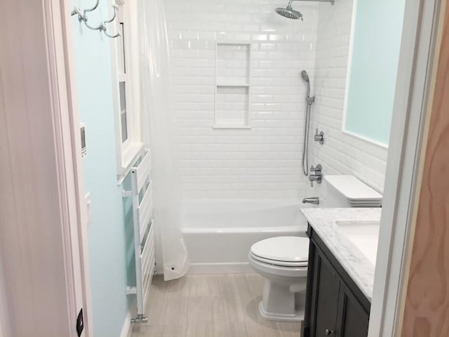 full bathroom with  shower combination, vanity, and toilet