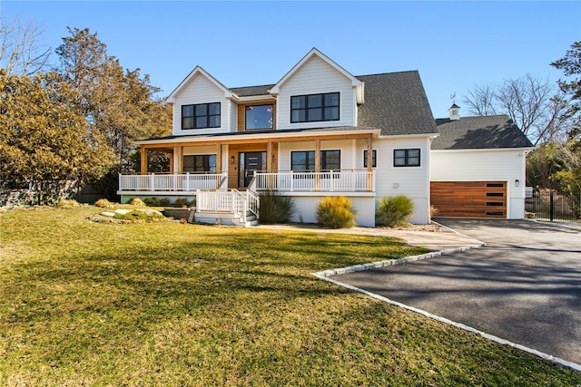 view of front of property featuring aphalt driveway, roof with shingles, a porch, an attached garage, and a front yard