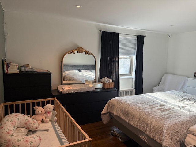 bedroom featuring dark wood-type flooring and recessed lighting