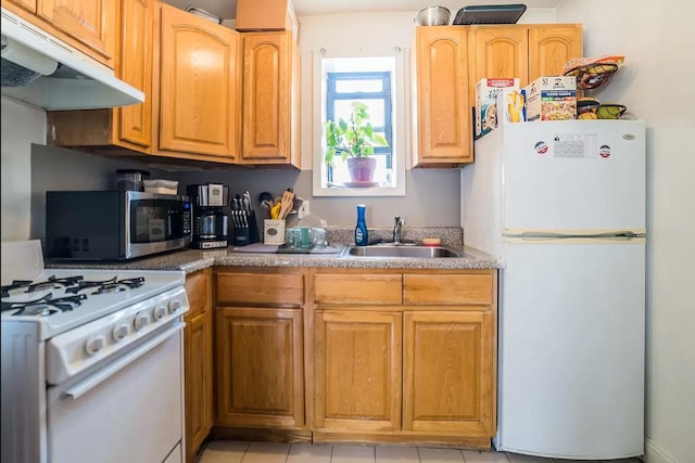 kitchen with white appliances, a sink, under cabinet range hood, and light tile patterned floors