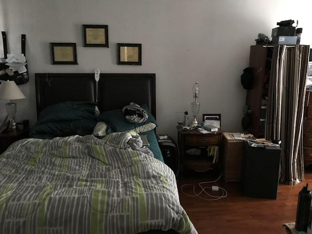 bedroom with dark wood finished floors