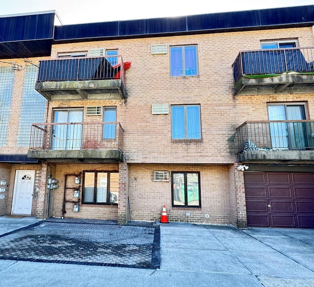 view of building exterior featuring a garage and driveway