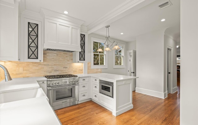 kitchen featuring light countertops, high end range, and white cabinetry