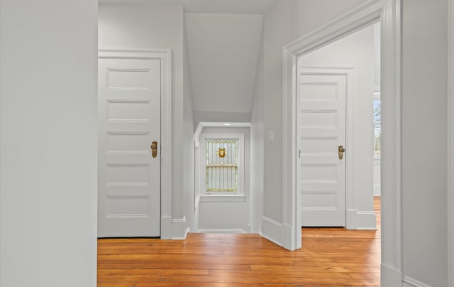 entryway featuring plenty of natural light, light wood-style flooring, and baseboards