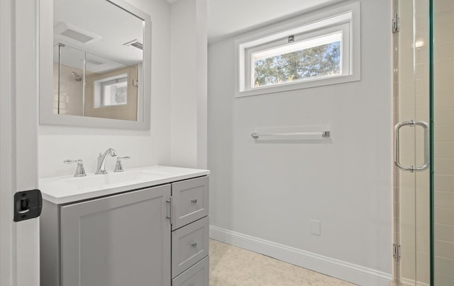 full bath with visible vents, a shower with door, vanity, and baseboards