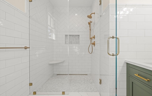 full bath with a shower stall and vanity