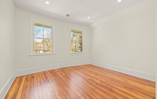 unfurnished room with recessed lighting, visible vents, baseboards, and hardwood / wood-style flooring