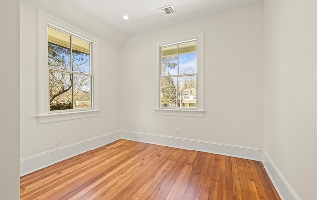 empty room with a healthy amount of sunlight and baseboards