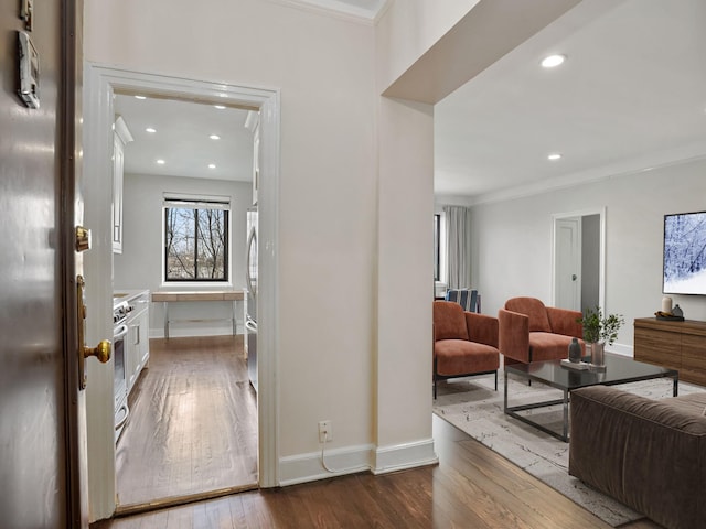 hall with recessed lighting, crown molding, baseboards, and hardwood / wood-style flooring