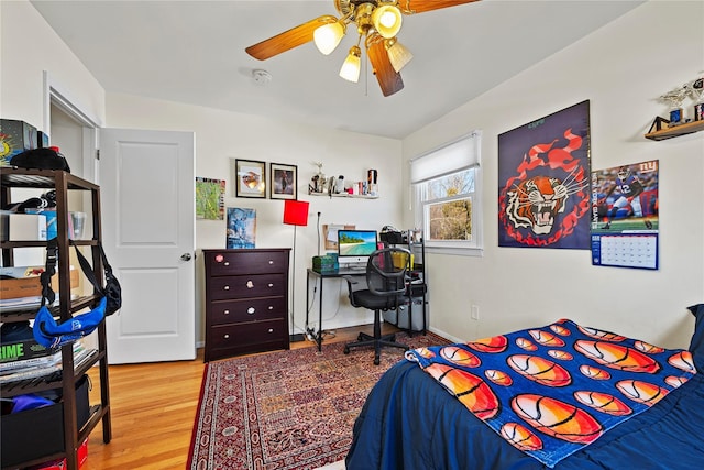 bedroom with a ceiling fan and light wood-type flooring