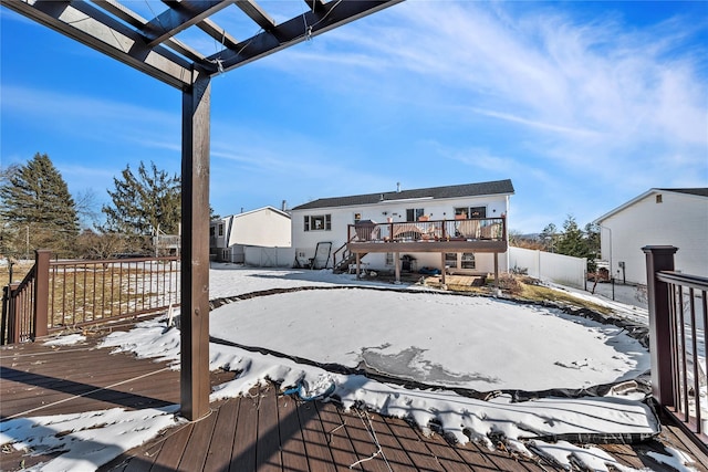 snow covered deck with fence and a pergola