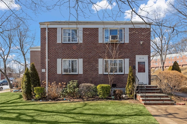 view of front of home featuring brick siding and a front lawn