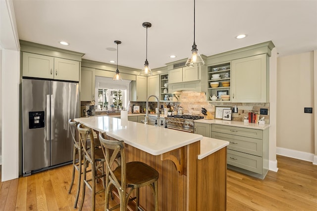 kitchen featuring stainless steel appliances, light wood-style floors, light countertops, backsplash, and open shelves