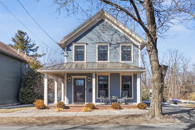 view of front of house featuring covered porch, metal roof, and a standing seam roof