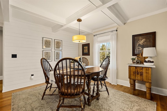 dining room featuring coffered ceiling, wood finished floors, baseboards, ornamental molding, and beamed ceiling