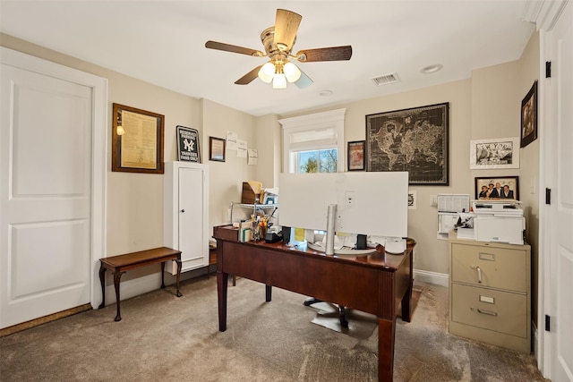 office space with baseboards, carpet flooring, visible vents, and a ceiling fan