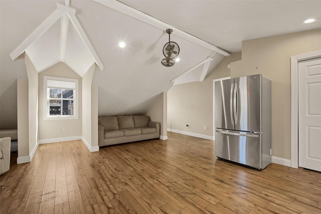 interior space with lofted ceiling, hardwood / wood-style floors, and baseboards